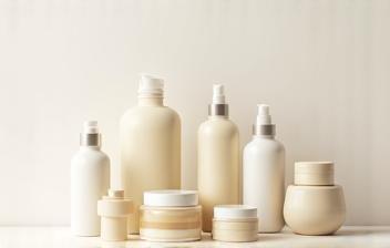 Bottles and jars of natural face creams, serums, and cleansers